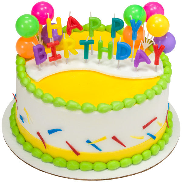 Round cake featuring "HAPPY BIRTHDAY" letter candles and balloons, with bright yellow and green icing details.