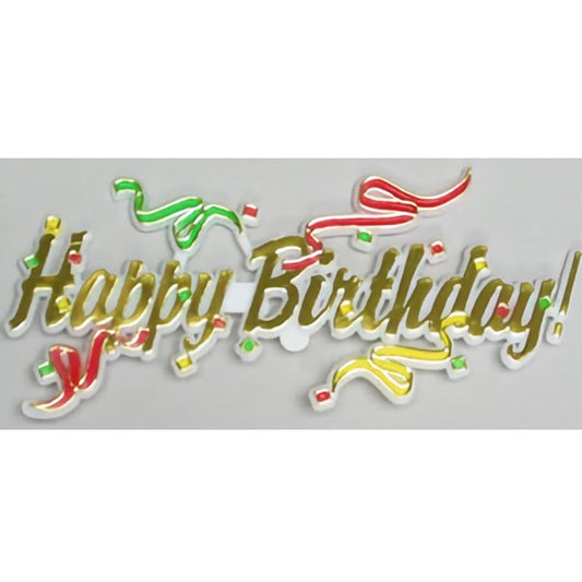 A festive "Happy Birthday" cake topper plaque featuring raised, silver-edged letters embellished with multicolored streamer details in red, yellow, and green, giving a three-dimensional illusion and a sense of movement to the decoration.