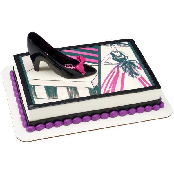 Fashion-themed sheet cake with illustration-style decorations, topped with the black high heel and magenta bow.