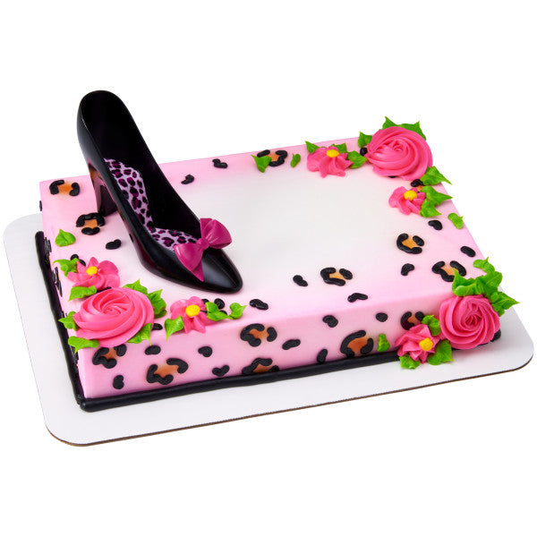 Decorated sheet cake with pink leopard print, black high heel topper, and piped pink buttercream roses.