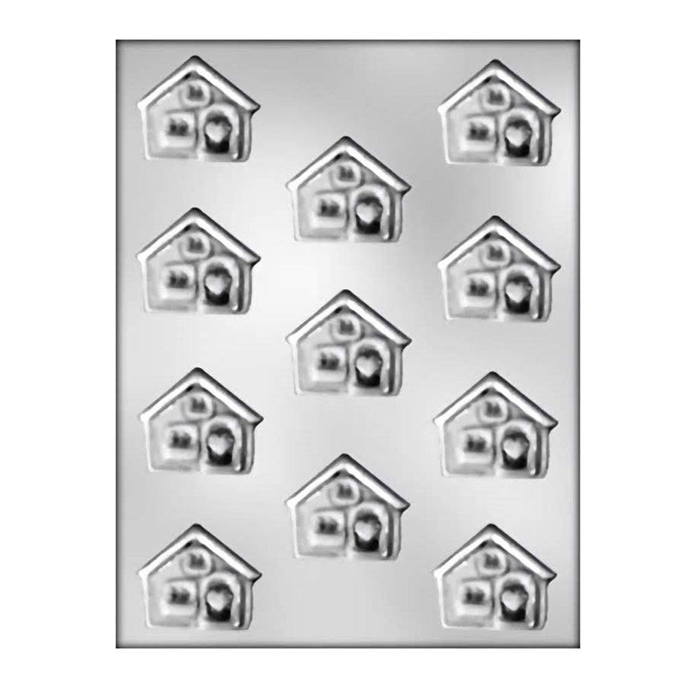 This image displays a chocolate mold featuring eleven cavities, each shaped like a quaint house with a heart in the center. The houses have a charming design with details resembling windows, a door, and a roof, evoking a cozy and inviting appearance.