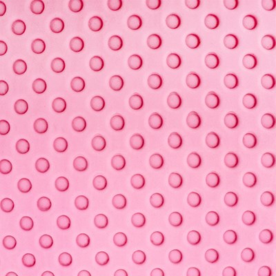 Close-up of classic dot pattern impressed on pink fondant using PME Impression Mat.