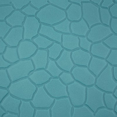Close-up of cobblestone pattern impressed on teal fondant using PME Impression Mat.