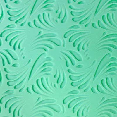 Elegant wave pattern impressed on green fondant using PME texture mat.