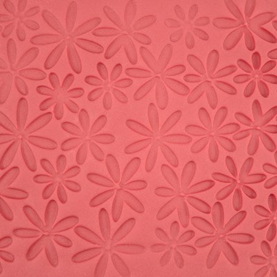 Floral daisy texture on pink fondant made using PME impression mat.