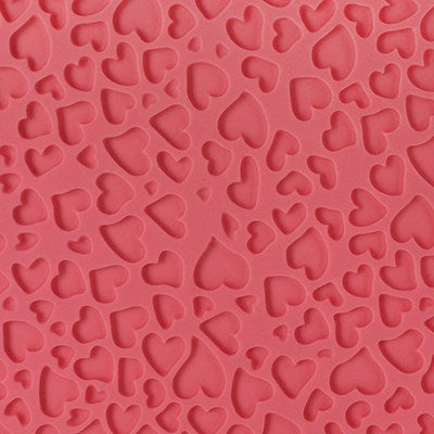 Mini heart pattern embossed in pink fondant using PME impression mat.