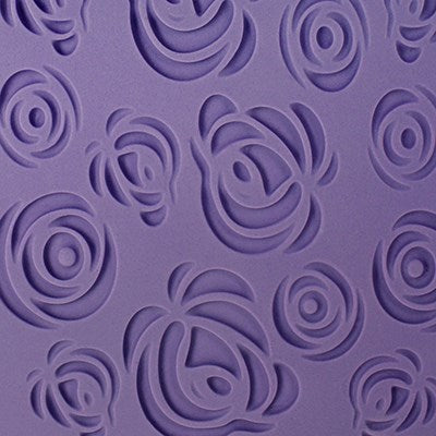 Close-up of purple fondant with embossed fantasy rose pattern from PME Impression Mat.