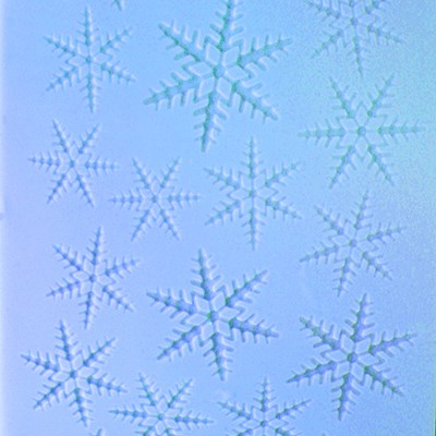 Close-up of snowflake embossed pattern on blue fondant using PME impression mat.