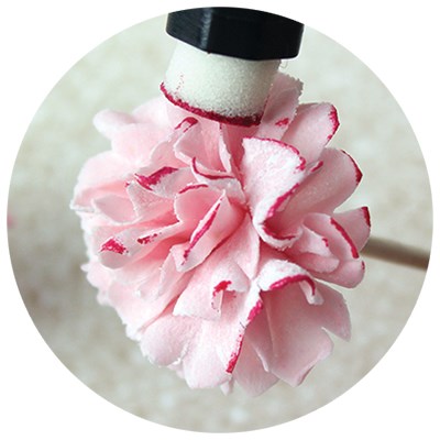 PME ink pad applying red tint to the edges of a pink sugar flower petal.