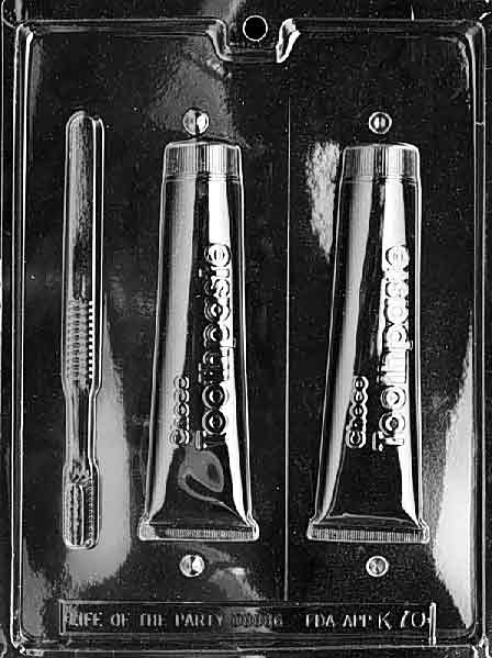 Image of K070 chocolate mold with 3D toothbrush and toothpaste shapes, realistic and playful for candy-making.