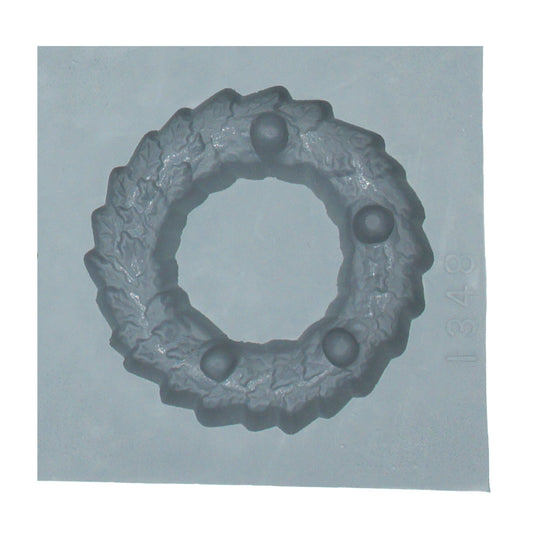 Close-up of large Christmas wreath rubber mint mold with holly leaf and berry detailing