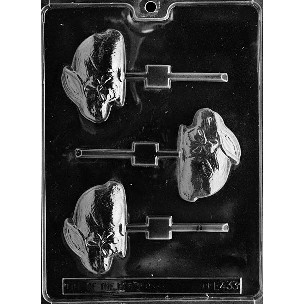 Clear plastic chocolate lollipop mold with three bunny-shaped cavities featuring a bow detail, each cavity connected to a stick channel, shown on a dark background.