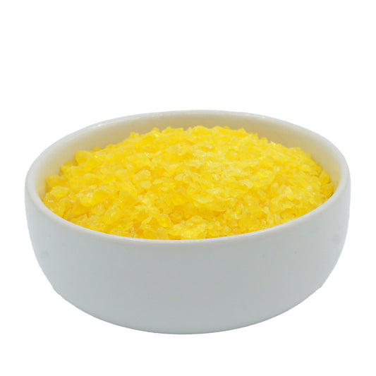 White bowl filled with crushed lemon candy pieces, ideal for adding flavor and crunch to chocolate bark and confections.