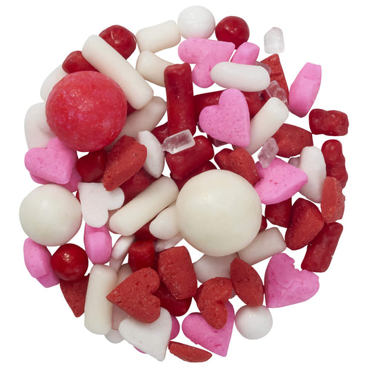 Close-up of Love Struck Deluxe Sprinkle Blend in a 3.2 oz pack, featuring a mix of pink and red candy shapes like hearts and lips, ideal for decorating cakes and desserts.