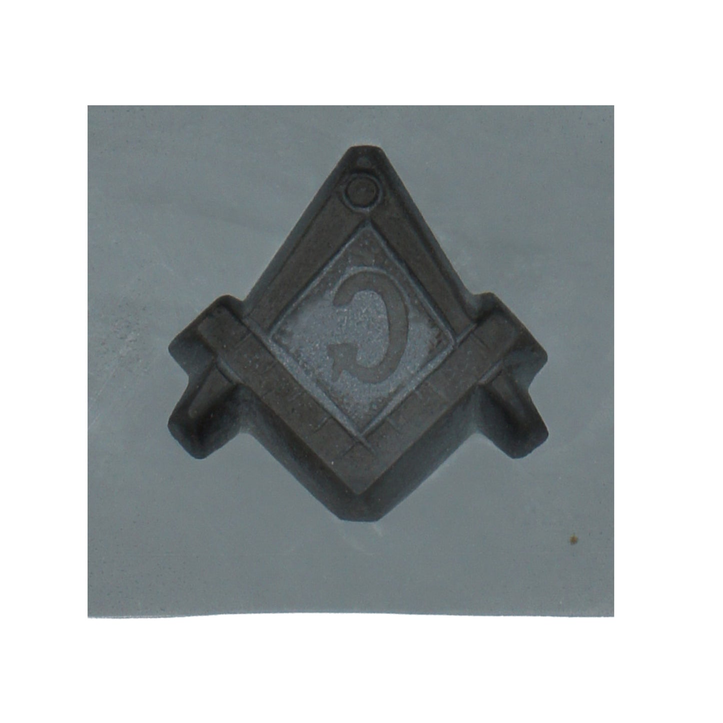 Close-up of a single cavity in the Masonic compass and square rubber mint mold, showcasing the detailed Masonic symbol for candy making.