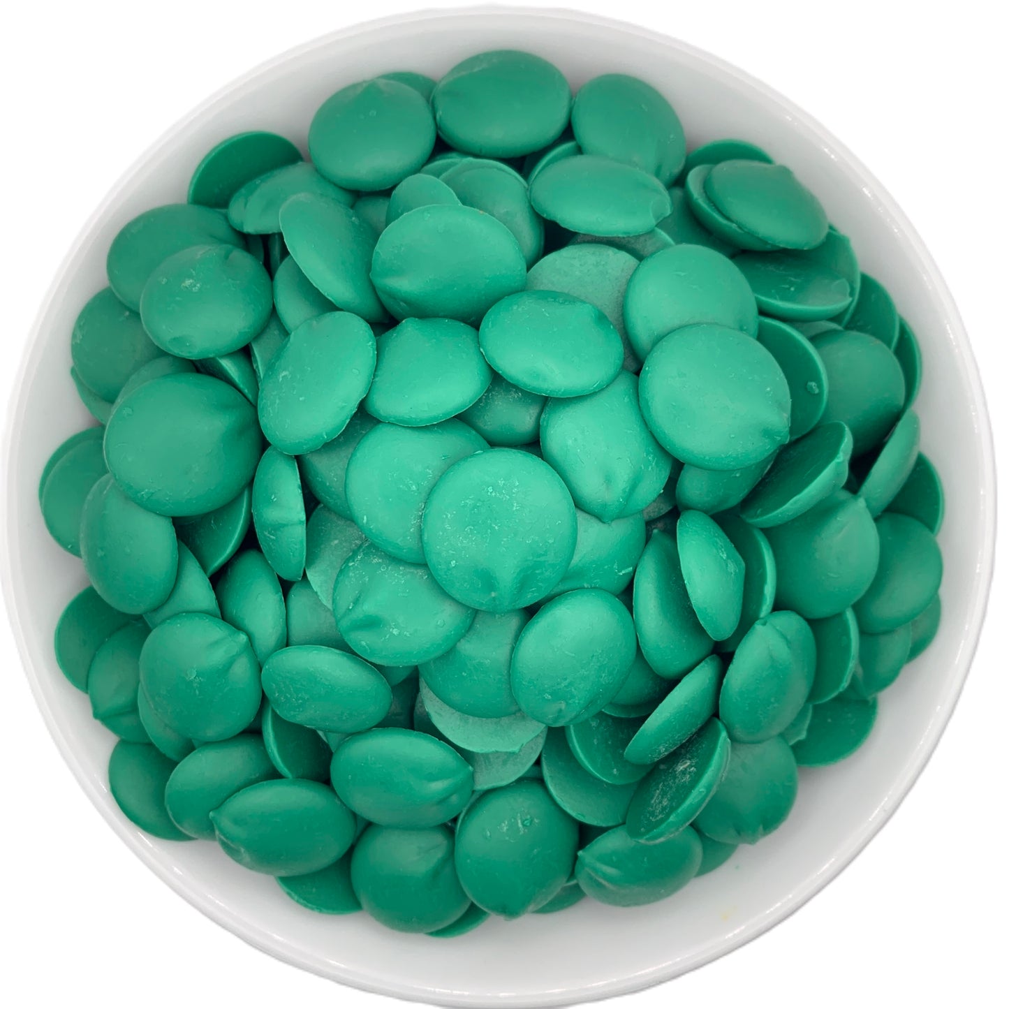 Top view of a white bowl full of Merckens dark green chocolate melting wafers, showcasing the vibrant green color perfect for themed desserts and festive treats.