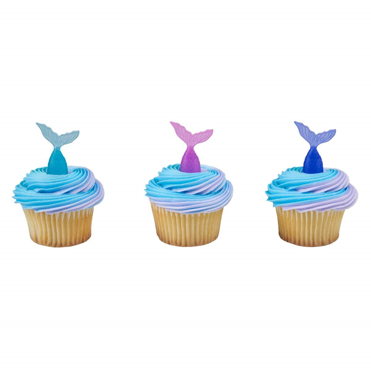 Assortment of mermaid tail cupcake toppers in blue and purple hues, designed to add a splash of ocean fantasy to cupcakes, featured at Lynn's Cake, Candy, and Chocolate Supplies.