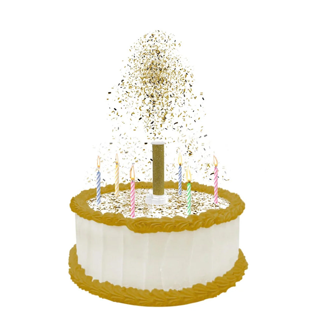 White frosted round cake with gold trim and colorful birthday candles, topped with a gold party popper releasing a shower of metallic edible confetti.
