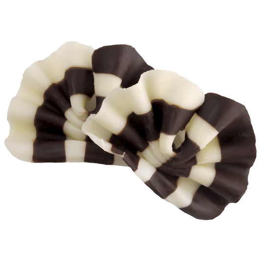 Intricately arranged dark and white Belgian chocolate shavings forming a decorative topping, showcasing a contrast of colors ideal for enhancing dessert presentations.