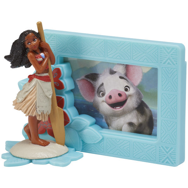 A Moana figurine with a paddle and a blue photo frame featuring Pua, designed as a cake topper.