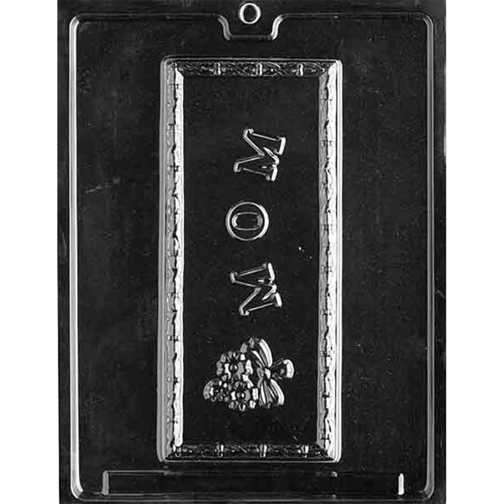 Clear plastic chocolate mold with one tall rectangular cavity featuring the word “MOM” and a small flower bouquet detail at the bottom.
