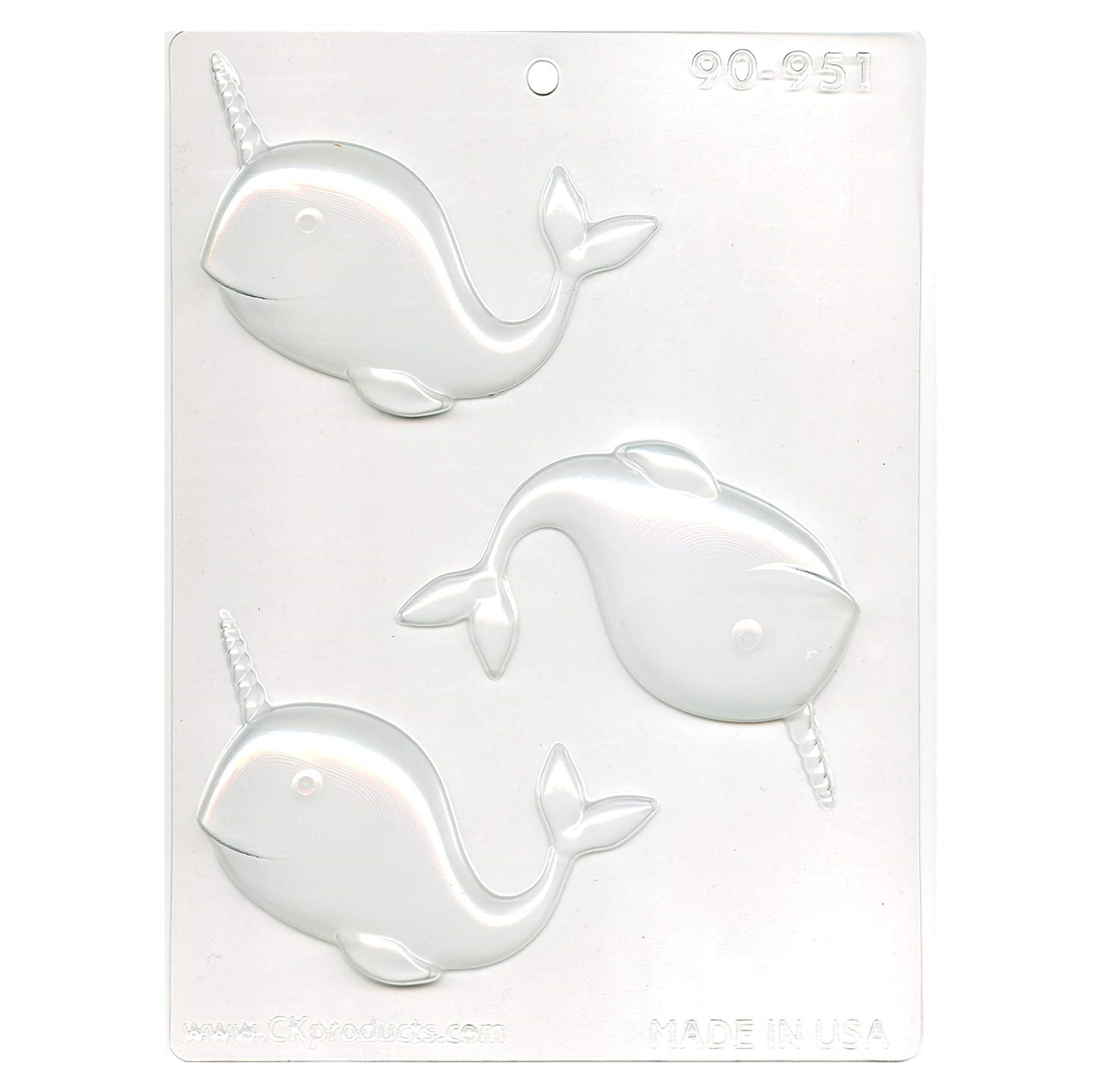 A clear plastic chocolate mold for creating narwhal-shaped treats, with three cavities each featuring the whimsical sea creature complete with a prominent tusk.