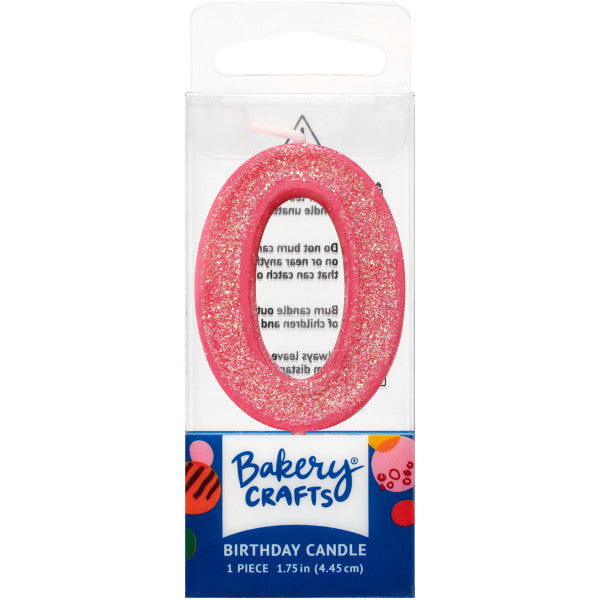 Glittery pink number zero 1.75" birthday candle in packaging from Bakery Crafts.