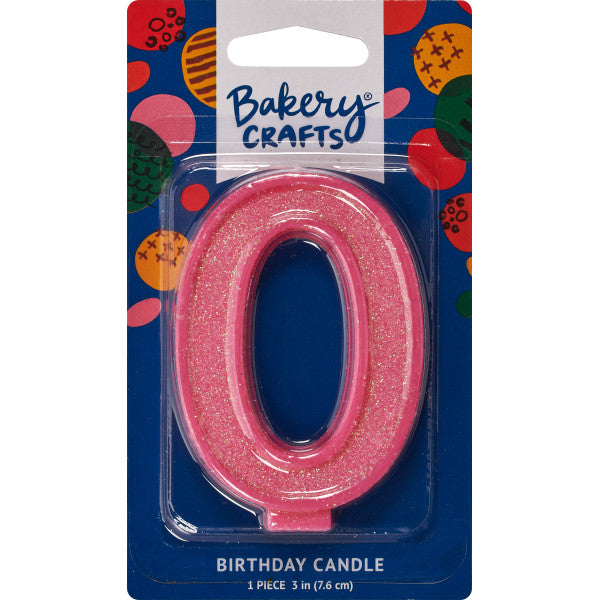 Glittery pink number zero 3" birthday candle in packaging from Bakery Crafts.