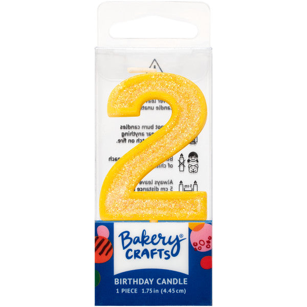 Glittery yellow number two 1.75" birthday candle in packaging from Bakery Crafts.