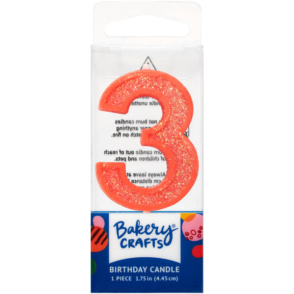 Glittery orange number three 1.75" birthday candle in packaging from Bakery Crafts.