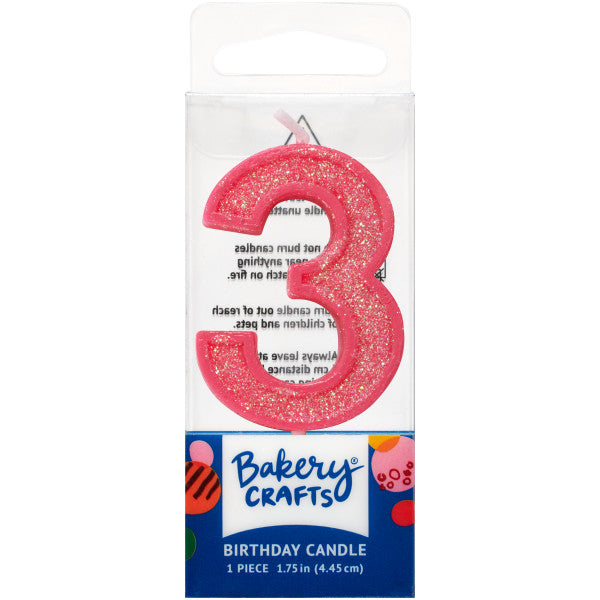 Glittery pink number three 1.75" birthday candle in packaging from Bakery Crafts.