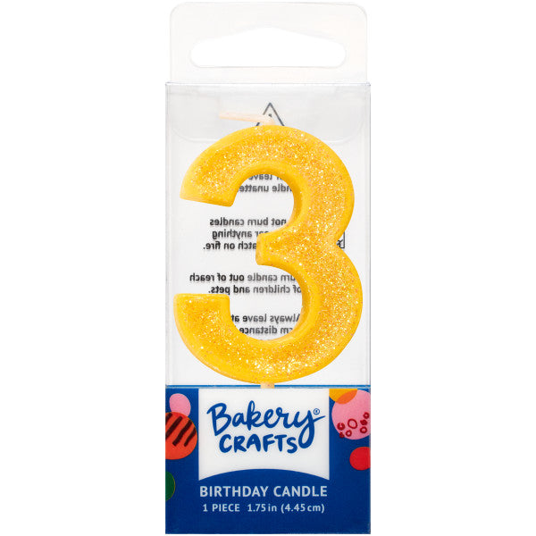 Glittery yellow number three 1.75" birthday candle in packaging from Bakery Crafts.