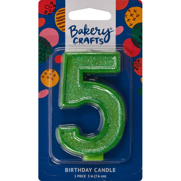 Glittery green number five 3" birthday candle in packaging from Bakery Crafts.