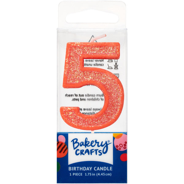 Glittery orange number five 1.75" birthday candle in packaging from Bakery Crafts.