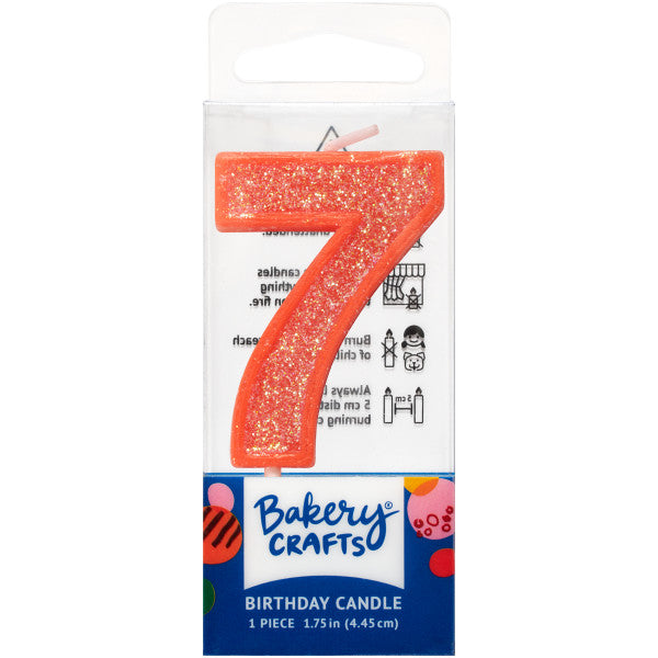 Glittery orange number seven 1.75" birthday candle in packaging from Bakery Crafts.