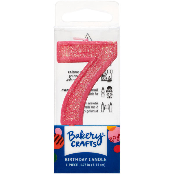 Glittery pink number seven 1.75" birthday candle in packaging from Bakery Crafts.
