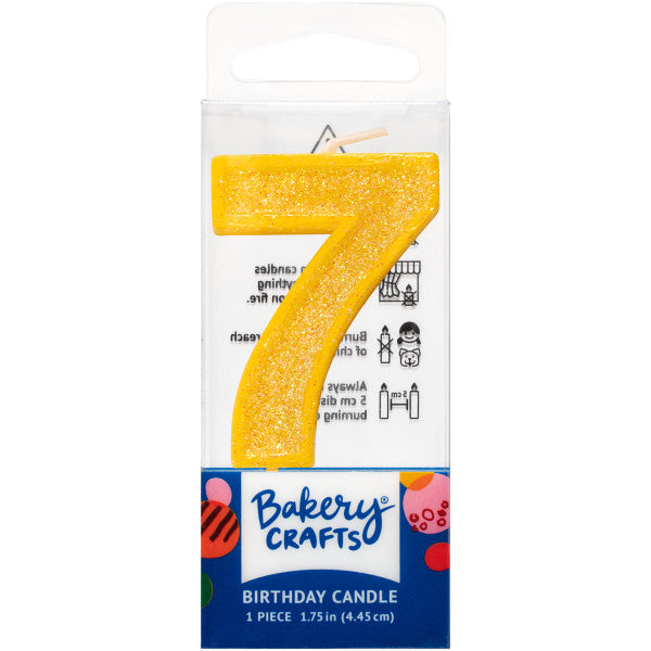 Glittery yellow number seven 1.75" birthday candle in packaging from Bakery Crafts.