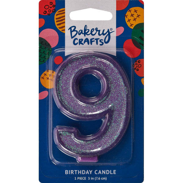 Glittery purple number nine 3" birthday candle in packaging from Bakery Crafts.