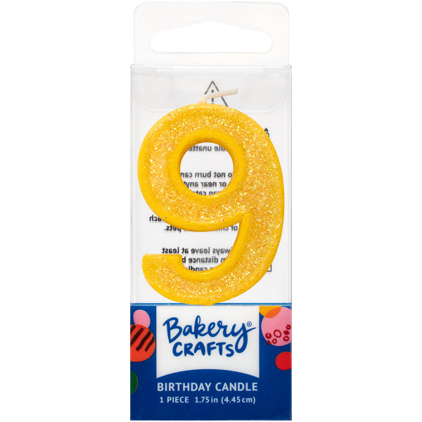 Glittery yellow number nine 1.75" birthday candle in packaging from Bakery Crafts.