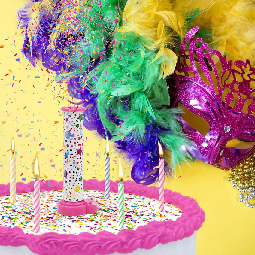 A birthday cake with candles and a Party Popper Cake Topper launching colorful edible confetti.