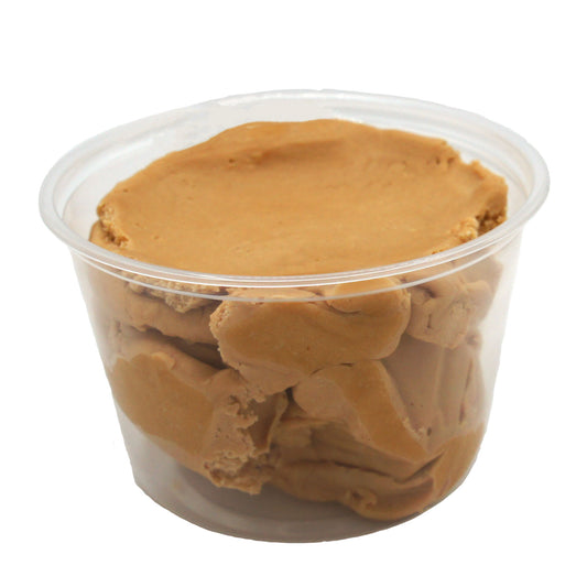 Clear plastic container filled with smooth, light brown peanut butter candy center, ready to shape and dip.