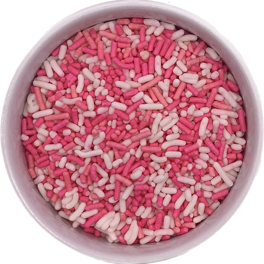 Bowl filled with pink and white jimmies sprinkles, ideal for decorating cupcakes, cookies, and sweet seasonal desserts.