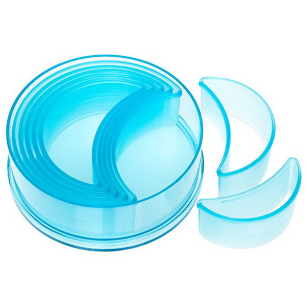 Ateco 5756 7-piece plain crescent cutter set in transparent blue plastic, neatly nested in a round storage container with two cutters displayed separately.