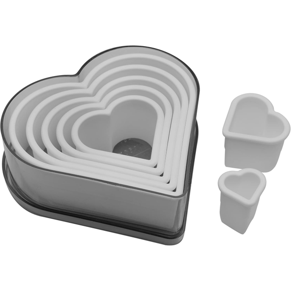 Ateco 5751 7-piece plain heart cutter set, featuring white plastic heart-shaped cutters neatly nested inside a matching heart-shaped storage container.