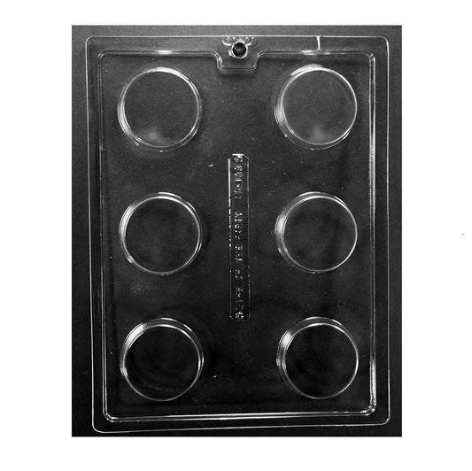 Clear six-cavity chocolate mold on a dark background, each cavity forming a thick, smooth-faced round disc about 2.25" wide x 0.75" deep; decorate-forward cookie mold.