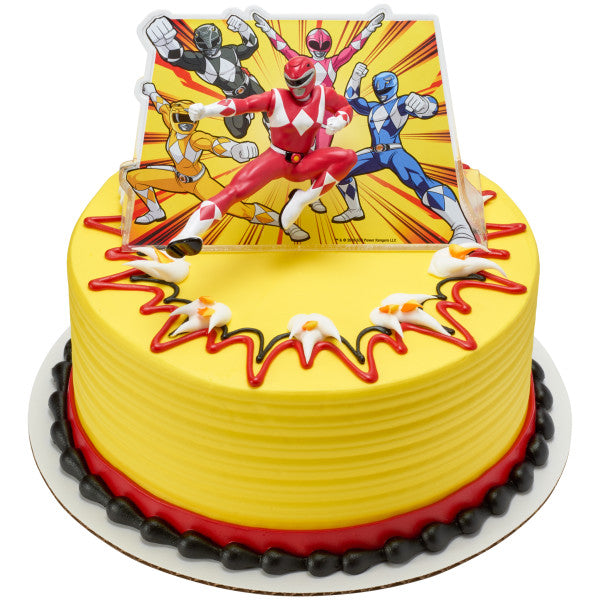 Round yellow cake with red and black trim, topped with Power Rangers Morphin Time Red Ranger figurine and illustrated background.