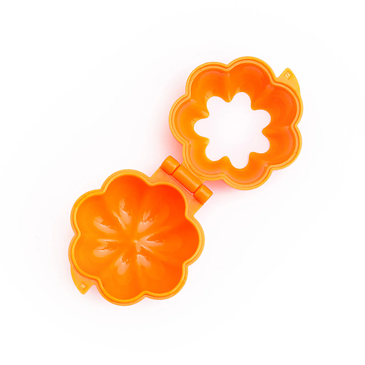 Open view of pumpkin cake pop mold showing detailed cavity with curved segments for shaping 3D pumpkin cake pops.