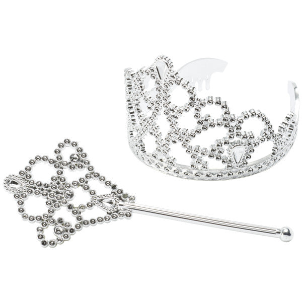 Close-up of silver crown and scepter cake toppers with gem-style detailing