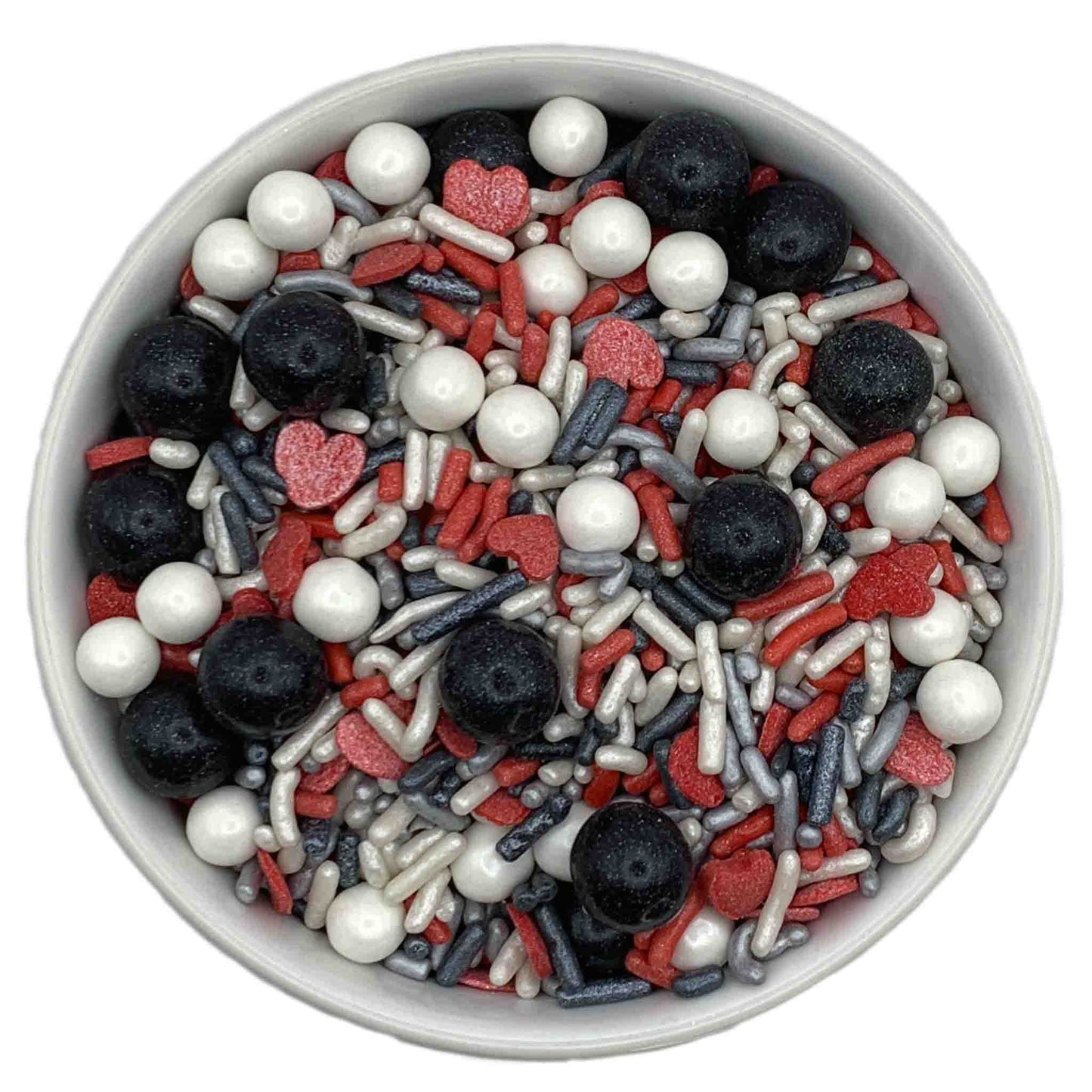 Bowl of Queen of Hearts Sprinkle Blend featuring black Sixlets, white sugar pearls, red heart confetti, silver nonpareils, and red, silver, and grey jimmies, sold in 3.2-ounce containers.