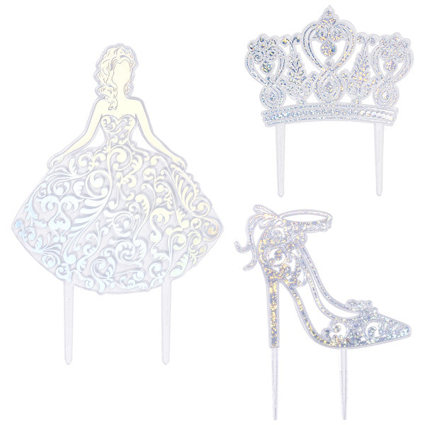 Silver Quinceañera cake topper set with a girl silhouette, jeweled crown, and high heel shoe, all with silver foil detailing.